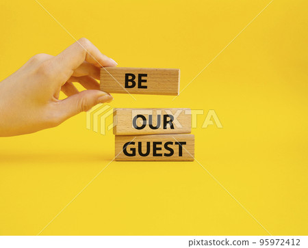 Be our guest symbol. Concept word Be our guest on wooden blocks. Beautiful yellow background. Businessman hand. Business and Be our guest concept. Copy space Be our guest symbol. Concept word Be our guest on wooden blocks. Beautiful yellow background. Businessman hand. Business and Be our guest concept. Copy space 95972412