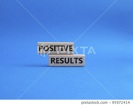 Positive results symbol. Concept words 'Positive results' on wooden blocks. Beautiful blue background. Business and Positive results concept. Copy space. 95972414