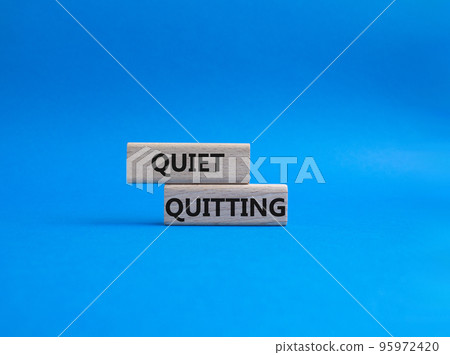 Quiet quitting symbol. Concept word Quiet quitting on wooden blocks. Beautiful blue background. Business and Quiet quitting concept. Copy space. Quiet quitting symbol. Concept word Quiet quitting on wooden blocks. Beautiful blue background. Business and Quiet quitting concept. Copy space. 95972420