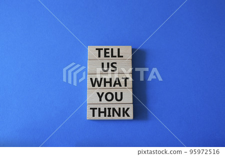 Tell us what you think symbol. Wooden blocks with words Tell us what you think. Beautiful blue background. Business and Tell us what you think concept. Copy space. 95972516