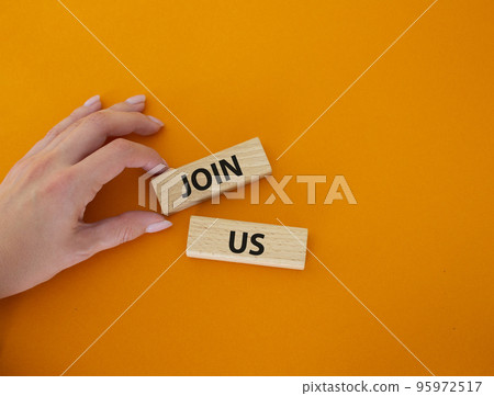 Join us symbol. Concept word Join us on wooden blocks. Beautiful orange background. Businessman hand. Business and Join us concept. Copy space Join us symbol. Concept word Join us on wooden blocks. Beautiful orange background. Businessman hand. Business and Join us concept. Copy space 95972517