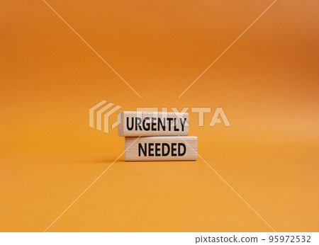 Urgently needed symbol. Concept word Urgently needed on wooden blocks. Beautiful orange background. Business and Urgently needed concept. Copy space 95972532