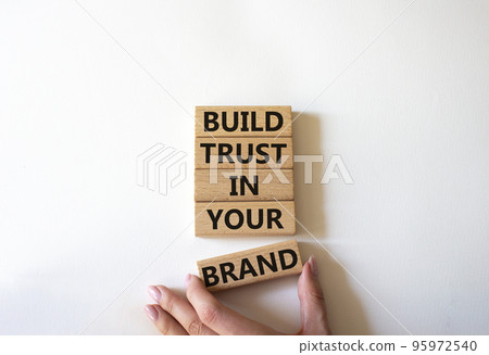 Build trust in your brand symbol. Wooden blocks with words Build trust in your brand. Beautiful white background. Businessman hand. Business and Build trust in your brand concept. Copy space. Build trust in your brand symbol. Wooden blocks with words Build trust in your brand. Beautiful white background. Businessman hand. Business and Build trust in your brand concept. Copy space. 95972540