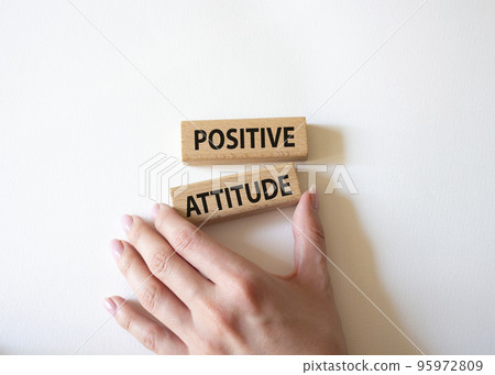 Positive attitude symbol. Concept words Positive attitude on wooden blocks. Beautiful white background. Businessman hand. Business and Positive attitude concept. Copy space. Positive attitude symbol. Concept words Positive attitude on wooden blocks. Beautiful white background. Businessman hand. Business and Positive attitude concept. Copy space. 95972809