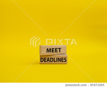 Meet Deadlines symbol. Concept word Meet Deadlines on wooden blocks. Beautiful yellowbackground. Business and Meet Deadlines concept. Copy space 95972885