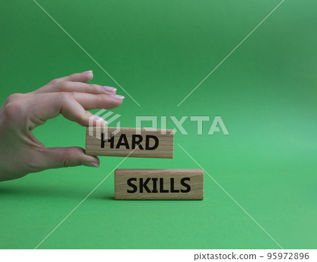 Hard skills symbol. Wooden blocks with words Hard skills. Beautiful green background. Businessman hand. Business and Hard skills concept. Copy space. 95972896