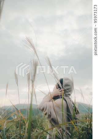 Photo of a woman standing in nature 95973173