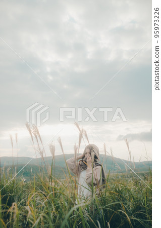 Photo of a woman standing in nature Photo of a woman standing in nature 95973226
