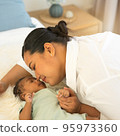 Portrait happy smiling beautiful mother kissing newborn baby 95973360