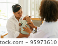 Newborn baby boy visiting the doctor for checkup health 95973610