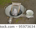 Washing clothes in the traditional way by hand 95973634