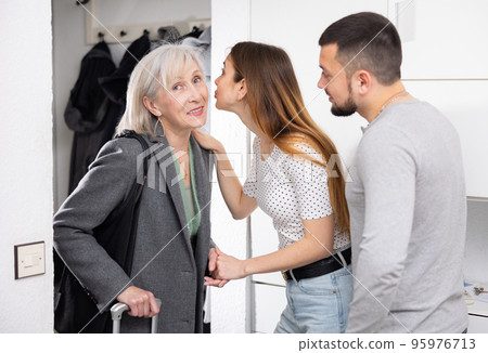 Mother visits her adult children at their home Mother visits her adult children at their home 95976713