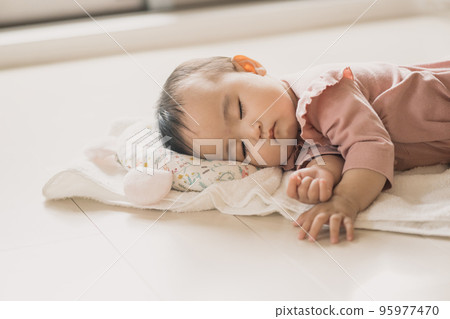 baby lying on a towel 95977470