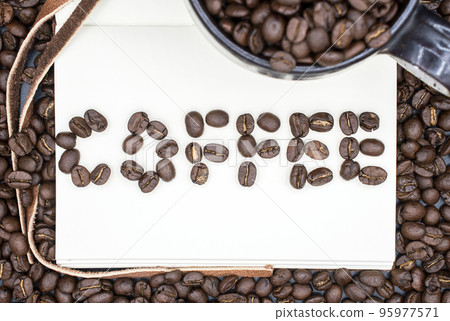 A book with a words of "Coffee" made by the roasted coffee beans with isolated black background. 95977571