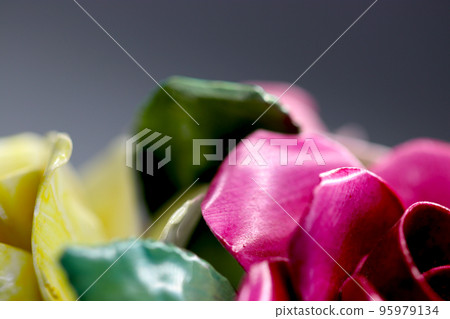 Macro close-up photography of a retro pottery figurine with botanical decoration, mainly a crimson rose flower decoration. Macro close-up photography of a retro pottery figurine with botanical decoration, mainly a crimson rose flower decoration. 95979134