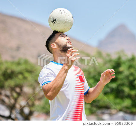 Sports, soccer and man soccer player training, balance and ball, head and soccer field, practice and cardio. Football, football player and trick during fitness, workout and exercise by mexican player 95983309