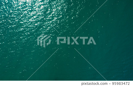 Aerial view of sea surface water texture background and sun reflections Aerial flying drone view Waves water surface texture on sunny tropical ocean in Phuket island Thailand 95983472