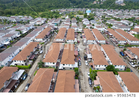 New development real estate. Aerial view of residential houses and driveways neighborhood during a fall sunset or sunrise time.Tightly packed homes.Top down view over private houses in phuket thailand New development real estate. Aerial view of residential houses and driveways neighborhood during a fall sunset or sunrise time.Tightly packed homes.Top down view over private houses in phuket thailand 95983478