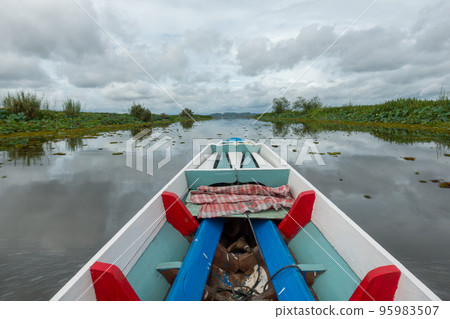 Fishing boat in a lake water in the morning,Old wooden fishing boat, wooden fishing boat in a lake water Beautiful landscape nature view in Talay noi Phatthalung Thailand 95983507