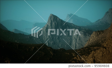 silhouette of swiss alps mountains in morning clouds 95984608