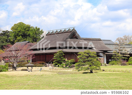 Ancient pavilion and stone lantern in Koishikawa Korakuen garden, Okayama, Japan Ancient pavilion and stone lantern in Koishikawa Korakuen garden, Okayama, Japan 95986102