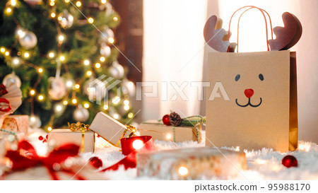 Christmas gif box on the white carpet against the tree Christmas gif box on the white carpet against the tree 95988170