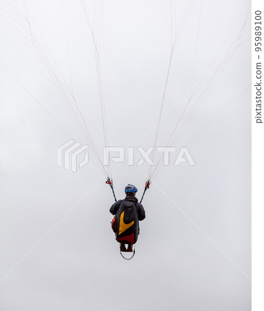 Skydiving extreme sports- parachutist with a parachute unfolded. 95989100