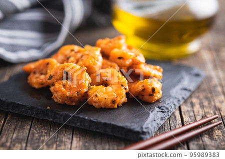 Grilled tiger shrimps on wooden table. 95989383