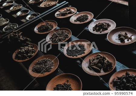 Various spices displaied on small ceramic and metal plates on black wooden background Various spices displaied on small ceramic and metal plates on black wooden background 95990574