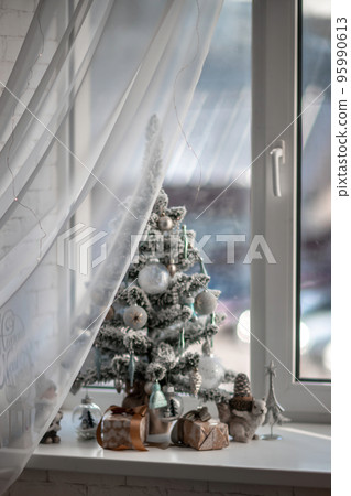 Window sill with New Year's elements - Christmas trees, decorations, Christmas balls. Merry Christmas and Happy New Year greeting card. Cozy background Window sill with New Year's elements - Christmas trees, decorations, Christmas balls. Merry Christmas and Happy New Year greeting card. Cozy background 95990613