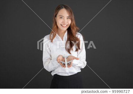 Business woman wearing white shirt Hand holding a white toy plane. Business woman wearing white shirt Hand holding a white toy plane. 95990727