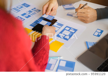 Developer team brainstorming on their project with laptop, smartphone, Creative digital development agency. Developer team brainstorming on their project with laptop, smartphone, Creative digital development agency. 95991120