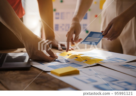 Developer team brainstorming on their project with laptop, smartphone, Creative digital development agency. Developer team brainstorming on their project with laptop, smartphone, Creative digital development agency. 95991121
