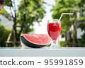 Watermelon juice and watermelon slices on the natural background. 95991859