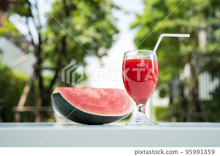 Watermelon juice and watermelon slices on the natural background. 95991859
