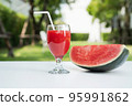 Watermelon juice and watermelon slices on the natural background. 95991862