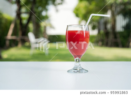 Watermelon juice and watermelon slices on the natural background. Watermelon juice and watermelon slices on the natural background. 95991863