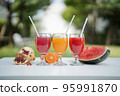 Orange juice, pomegranate juice and watermelon juice on the natural background 95991870