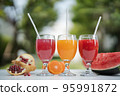 Orange juice, pomegranate juice and watermelon juice on the natural background 95991872