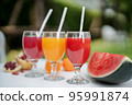 Orange juice, pomegranate juice and watermelon juice on the natural background 95991874