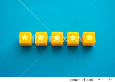 Five stars in a row on yellow blocks. Evaluation of the quality of the provided service. Feedback overview. Popularity, prestige. High reputation. Successful business, satisfied customers. 95992032