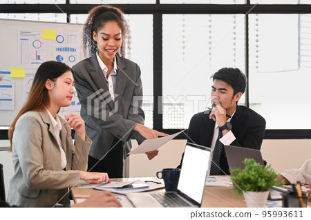 Businesspeople brainstorming new start up ideas, discussing financial paperwork at at briefing 95993611