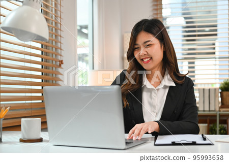 Smiling young woman financial advisor answering or giving consultation to customer on laptop computer Smiling young woman financial advisor answering or giving consultation to customer on laptop computer 95993658