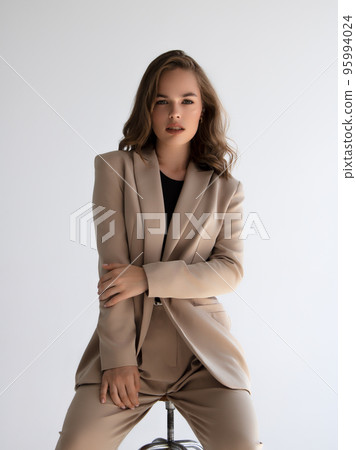 Beautiful model in a beige trend suit. Fashionable 95994024