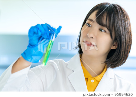 A woman in a white coat doing research 95994620