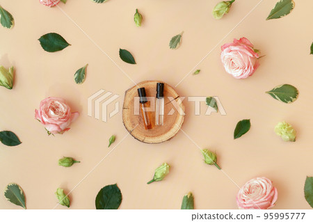 Wooden podium with perfume samples on trendy pastel beige background with flower buds, leaves, petals. Abstract cosmetics composition with roses. Beauty layout. Summer, spring, aroma water concept 95995777