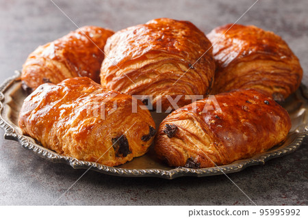 Delicious french buns Croissants Pain Au Chocolate closeup in the plate. Horizontal 95995992