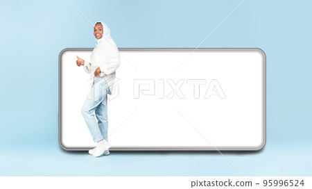 Excited african american woman near big smartphone with blank white screen gesturing thumb up, mock up, panorama Excited african american woman near big smartphone with blank white screen gesturing thumb up, mock up, panorama 95996524