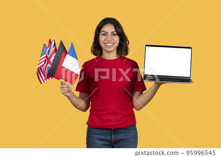 Happy middle eastern woman student holding diverse flags and laptop Happy middle eastern woman student holding diverse flags and laptop 95996545