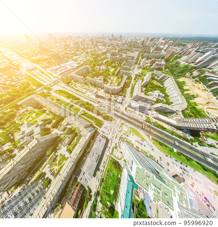 Aerial city view with crossroads and roads, houses, buildings, parks and parking lots. Sunny summer panoramic image Aerial city view with crossroads and roads, houses, buildings, parks and parking lots. Sunny summer panoramic image 95996920